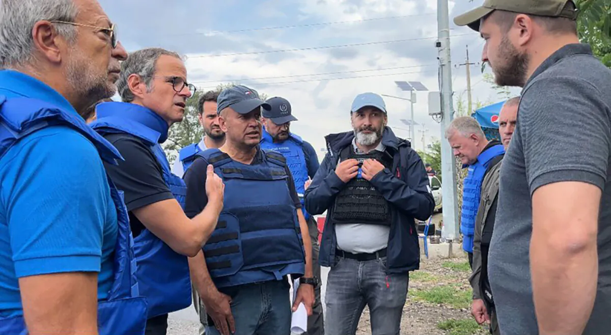The Director General of nuclear watchdog, Rafael Mariano Grossi (2nd L), speaks to unidentified authorities as the U.N. agency mission heads to the Zaporizhzhia nuclear power plant in Zaporizhzhia, Ukraine, on Sept. 1, 2022. (International Atomic Energy Agency via AP)