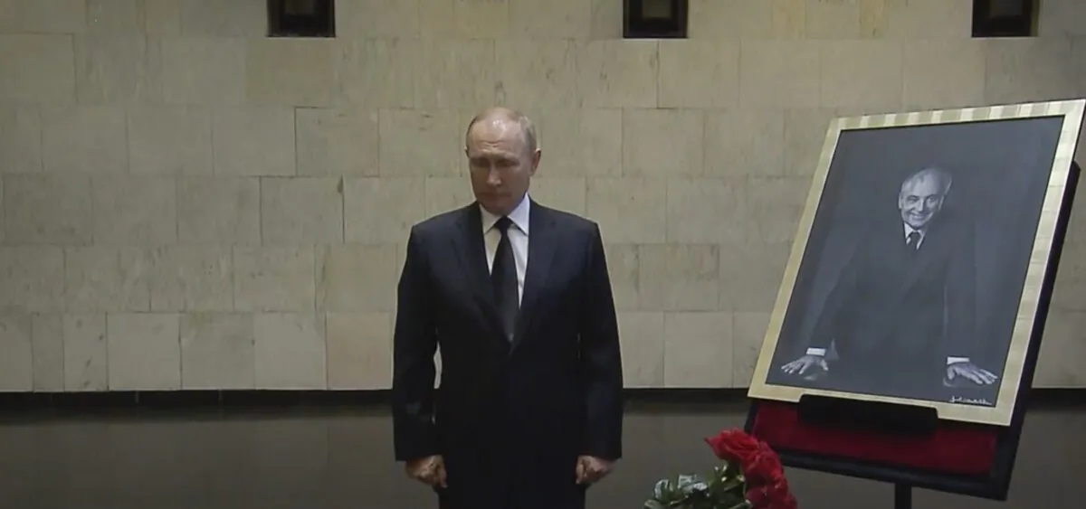Russian President Vladimir Putin pays his last respect near the coffin of former Soviet leader Mikhail Gorbachev at the Central Clinical Hospital in Moscow on Sept. 1, 2022, in an image taken from video. (Russian pool via AP)