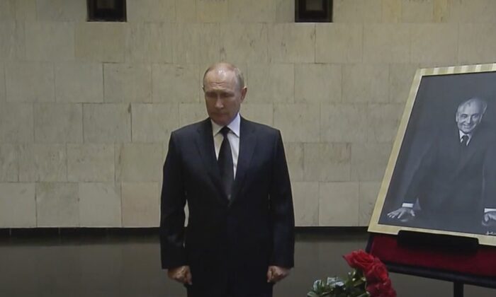 Russian President Vladimir Putin pays his last respect near the coffin of former Soviet leader Mikhail Gorbachev at the Central Clinical Hospital in Moscow on Sept. 1, 2022, in an image taken from video. (Russian pool via AP)