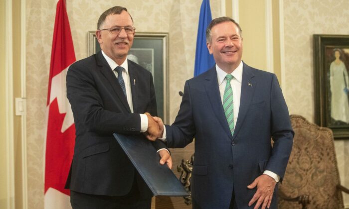 Ron Orr shakes hands with Alberta Premier Jason Kenney during a cabinet shuffle at Government House in Edmonton on July 8, 2021. (The Canadian Press/Jason Franson)