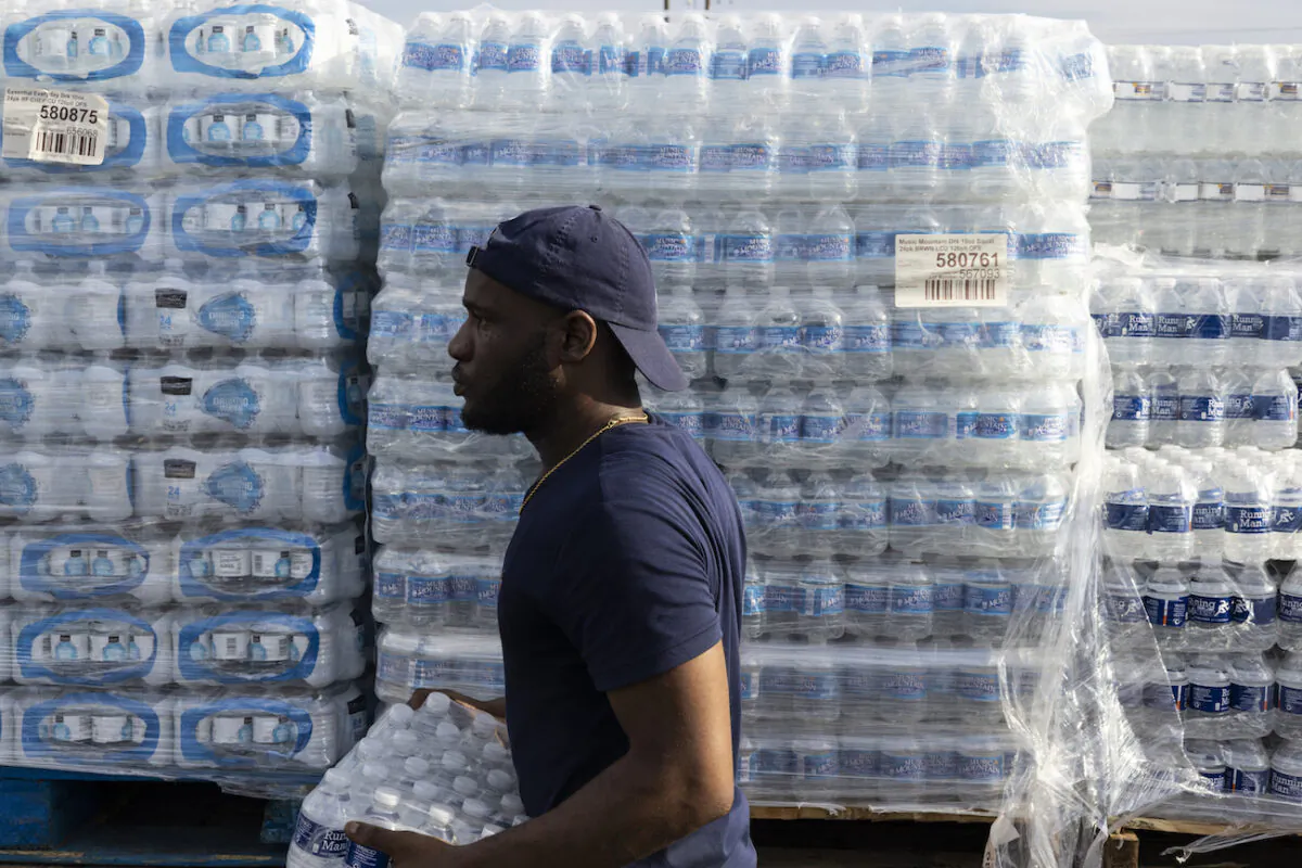 A City of Jackson employee helps hand out cases of bottled water at a Mississippi Rapid Response Coalition distribution site in Jackson, Mississippi, on Aug. 31, 2022. (Brad Vest/Getty Images)