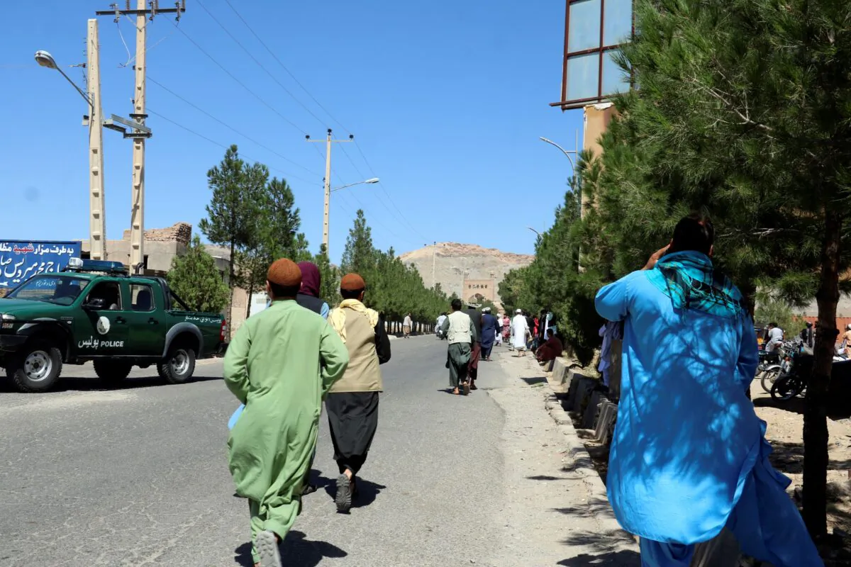 Afghan people run near the site of an explosion in Herat province, Afghanistan, on Sept. 2, 2022. (Omid Haqjoo/AP Photo)