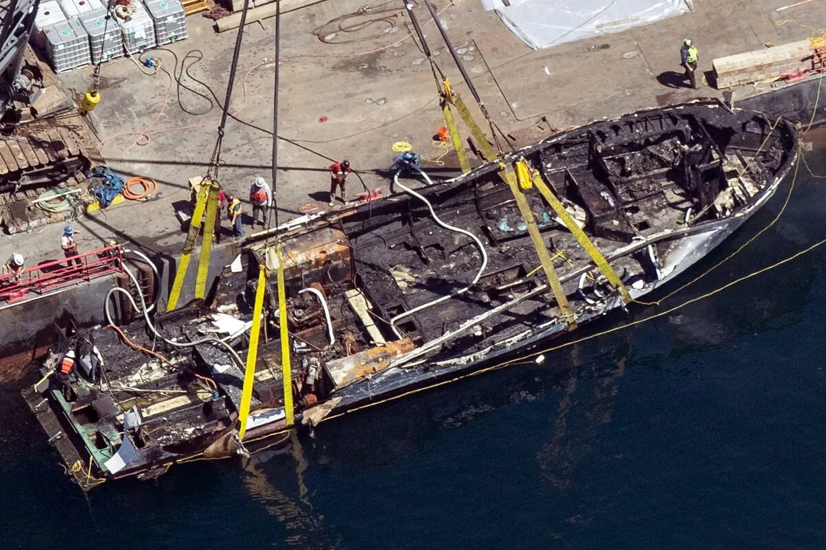 The burned hull of the dive boat Conception is brought to the surface by a salvage team in the Santa Barbara Channel off Santa Cruz Island in Southern California on Sept. 12, 2019. (Brian van der Brug/Los Angeles Times via AP)