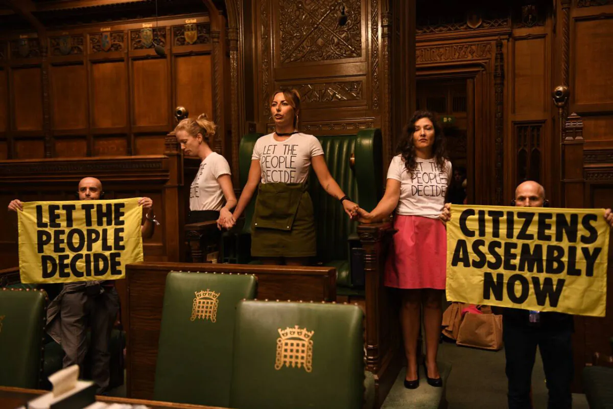 Extinction Rebellion protesters superglued themselves around the Speaker's chair in the House of Commons chamber, in London, on Sept. 2, 2022. (Extinction Rebellion/PA Media)