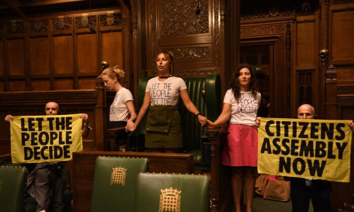 Extinction Rebellion protesters superglued themselves around the Speaker's chair in the House of Commons chamber, in London, on Sept. 2, 2022. (Extinction Rebellion/PA Media)