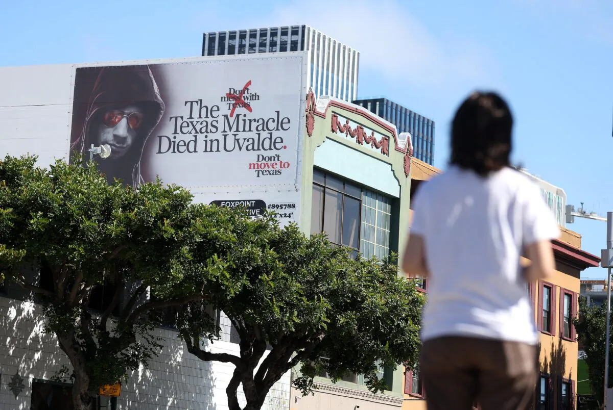 A view of a billboard that a warns people about moving to Texas, in San Francisco, Calif., on Aug. 25, 2022. Mysterious billboards have popped up in Los Angeles and San Francisco that warns residents about moving to Texas following the mass shooting at a Uvalde, Texas school that killed 21 people plus the gunman. (Justin Sullivan/Getty Images)