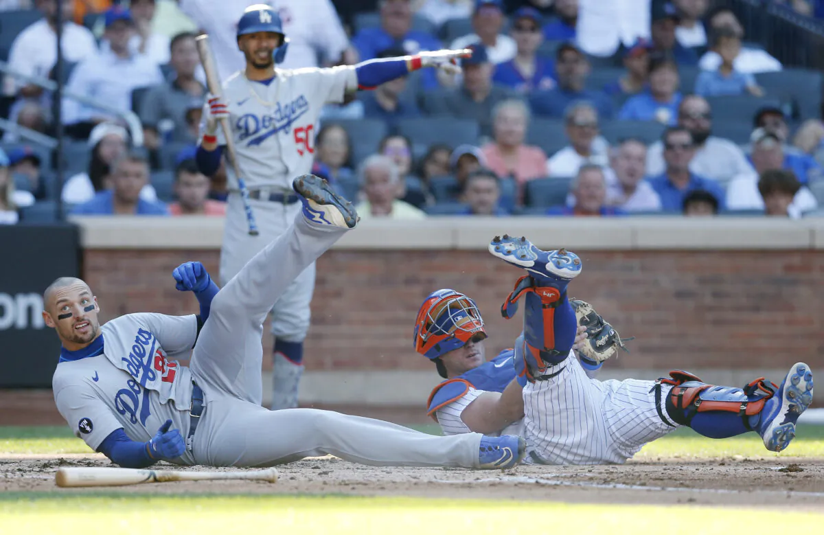 Trayce Thompson (25) of the Los Angeles Dodgers is tagged out at the plate during the second inning by James McCann (33) of the New York Mets at Citi Field in New York City, Sept. 1, 2022. (Jim McIsaac/Getty Images)