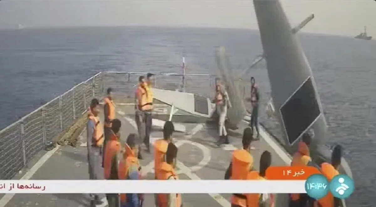 Iranian navy sailors throw an American sea drone overboard in the Red Sea on Sept. 1, 2022, in a frame grab from video. (Iranian state television via AP)
