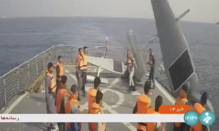 Iranian navy sailors throw an American sea drone overboard in the Red Sea on Sept. 1, 2022, in a frame grab from video. (Iranian state television via AP)
