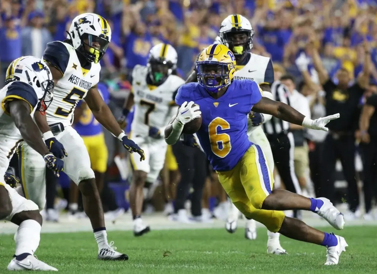 Pittsburgh Panthers running back Rodney Hammond Jr. (6) runs after a catch as West Virginia Mountaineers linebacker Lance Dixon (5) and cornerback Wesley McCormick (11) chase during the third quarter at Acrisure Stadium in Pittsburgh on Sept. 1, 2022. (Charles LeClaire/USA TODAY Sports via Field Level Media)