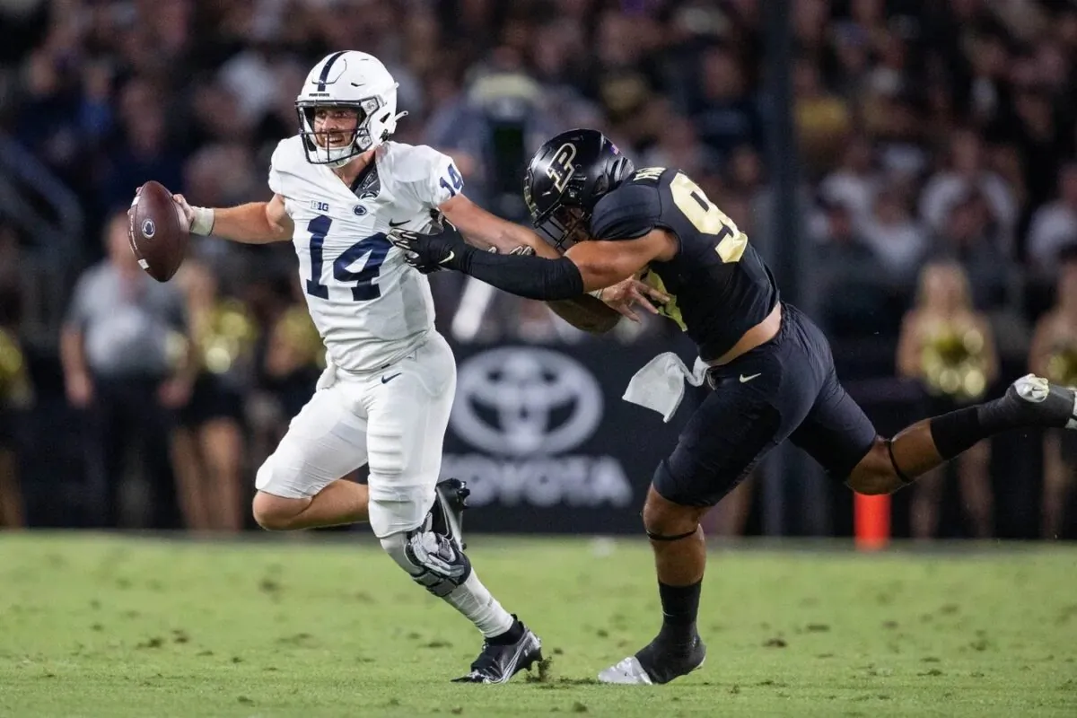 Penn State Nittany Lions quarterback Sean Clifford (14) runs to pass the ball while Purdue Boilermakers defensive tackle Lawrence Johnson (90) defends in the second quarter at Ross-Ade Stadium in West Lafayette, Ind., on Sept. 1, 2022. (Trevor Ruszkowski/USA TODAY Sports via Field Level Media)
