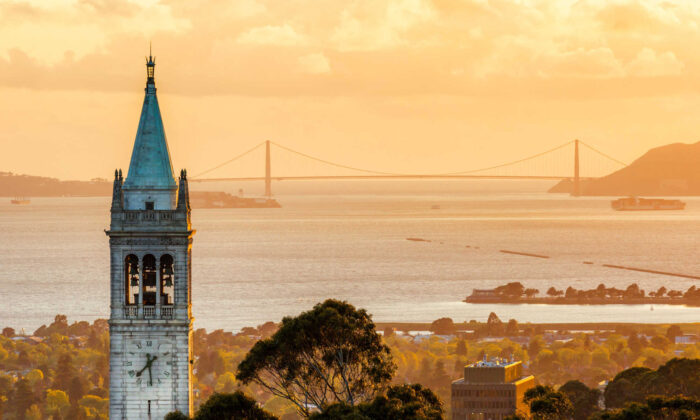 Sunset time Sather Tower at University of California, Berkeley campus, with Golden Gate Bridge in the background. (Guangli/Shutterstock)