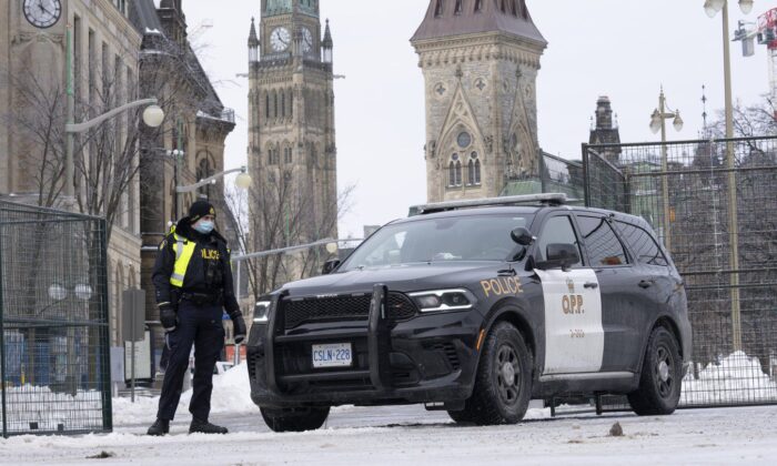 A police officer stands at a checkpoint near Parliament Hill on Feb. 23, 2022 in Ottawa. (The Canadian Press/Adrian Wyld)