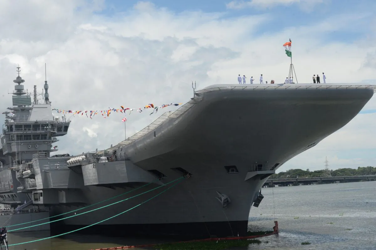 Indian navy officers gather on the deck of the Indian indigenous aircraft carrier INS Vikrant during its commissioning at Cochin Shipyard in Kochi, India, on Sept. 2, 2022. - India debuted its first locally made aircraft carrier, a milestone in government efforts to reduce its dependence on foreign arms and counter China's growing military assertiveness in the region. (Arun Sankar/AFP via Getty Images)