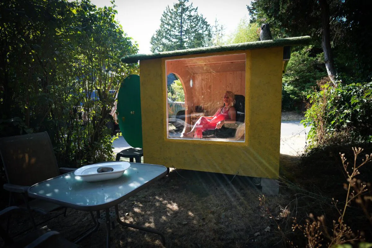 Anne Bruinn sits in her "Hobbit Hole Shed" that she and her husband offer for use to people who might want some time alone, in Vancouver, Sept. 2, 2022. (The Canadian Press/Darryl Dyck)