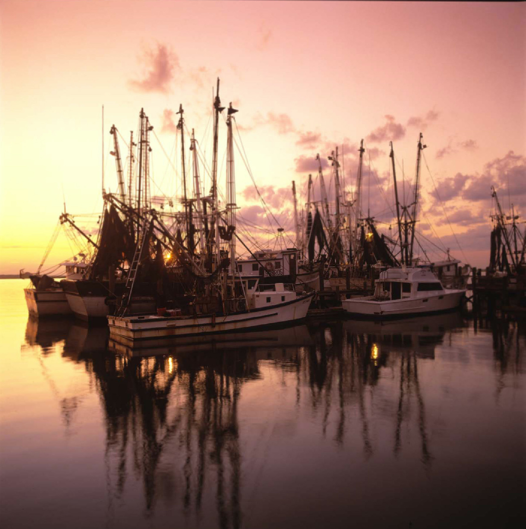 A sunset behind shrimp boats emphasizes the beauty of Amelia Island