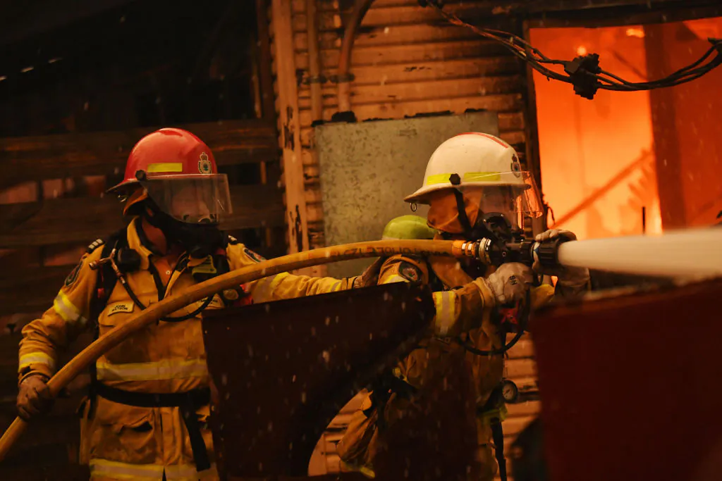 Rural Fire Service firefighters extinguish a fire on a property in Moruya, Australia, on Jan 23, 2020. (Sam Mooy/Getty Images)