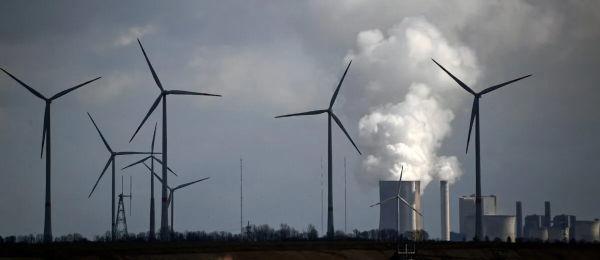 Wind turbines are seen near the coal-fired power station Neurath of German energy giant RWE in Garzweiler, Germany, on March 15, 2021. (Photo by Ina FASSBENDER / AFP) (Photo by INA FASSBENDER/AFP via Getty Images)