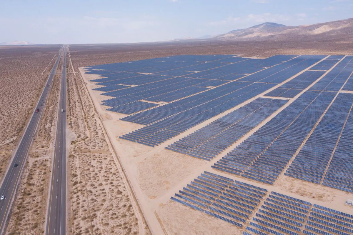 Vehicles drive on the California 14 Highway next to solar panels, part of an electricity generation plant, in Kern County near Mojave, Calif., on June 18, 2021. (Patrick T. Fallon/AFP via Getty Images)