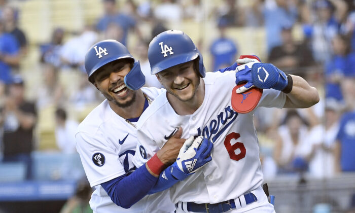 Trea Turner (6) of the Los Angeles Dodgers is congratulated by Mookie Betts (50) after hitting a two-run home run against starting pitcher Sean Manaea (55) of the San Diego Padres during the first inning  at Dodger Stadium in Los Angeles, on Sept. 3, 2022. (Kevork Djansezian/Getty Images)

