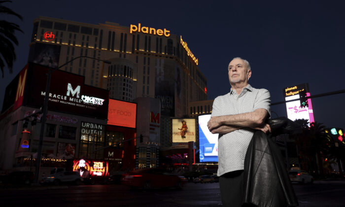 Jeff German, host of "Mobbed Up," poses with Planet Hollywood, formerly the Aladdin, in the background on the Strip in Las Vegas on June 2, 2021. (K.M. Cannon/Las Vegas Review-Journal via AP)