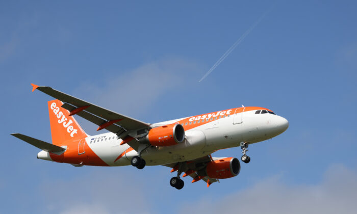 An easyJet aeroplane comes in for landing at Gatwick Airport in London on March 27, 2022. (Hollie Adams/Getty Images)