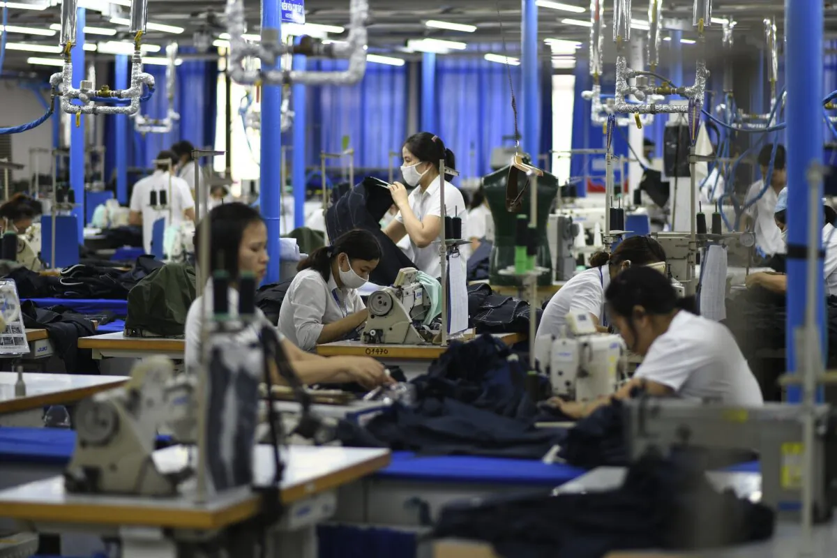 Garment factory workers making men's suits in a factory in Hanoi, Vietnam on May 24, 2019. (Manan Vatsyayana/AFP via Getty Images)