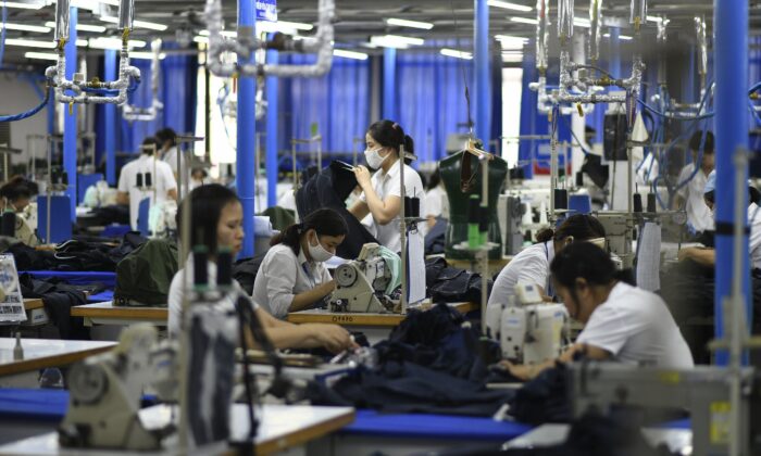 Garment factory workers making men's suits in a factory in Hanoi, Vietnam on May 24, 2019. (Manan Vatsyayana/AFP via Getty Images)