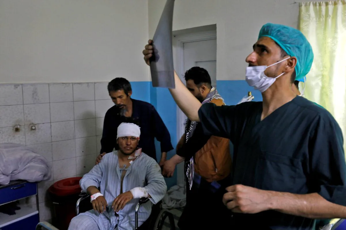 A medic checks an X-ray film of a man who was wounded after a suicide bomber detonated explosives near the entrance of the Russian embassy, inside a hospital in Kabul, Afghanistan, on Sept. 5, 2022. (Ali Khara/Reuters)