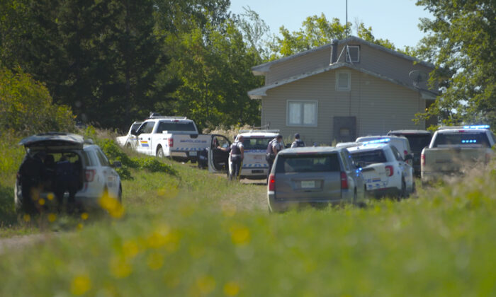 In this image taken from video, Canadian law enforcement personnel surrounded a residence on the James Smith Cree First Nation reservation in Saskatchewan on Sept. 6, 2022, as they search for a suspect in a series of stabbings. (AP Photo/Robert Bumsted)