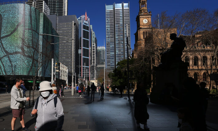 Pedestrians and shoppers make their way through the central business district in Sydney, Australia, on July 17, 2022. (Lisa Maree Williams/Getty Images)