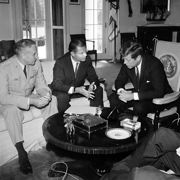 (L–R) Army Chief-of-Staff Gen. Maxwell Taylor, Secretary of Defense Robert McNamara, and President John F. Kennedy confer on Sept. 24, 1963 at the White House prior to their visit to South Vietnam to review U.S. military efforts. (Stringer/AFP via Getty Images)