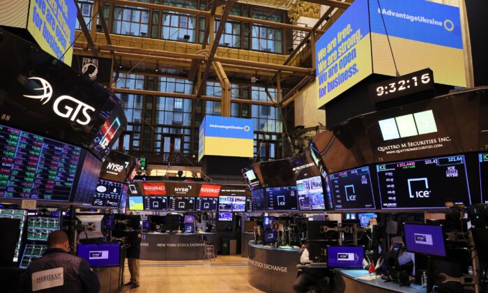 Traders work on the floor of the New York Stock Exchange in New York on Sept. 6, 2022, as an Advantage Ukraine Initiative message is displayed on screens during morning trading. (Michael M. Santiago/Getty Images)