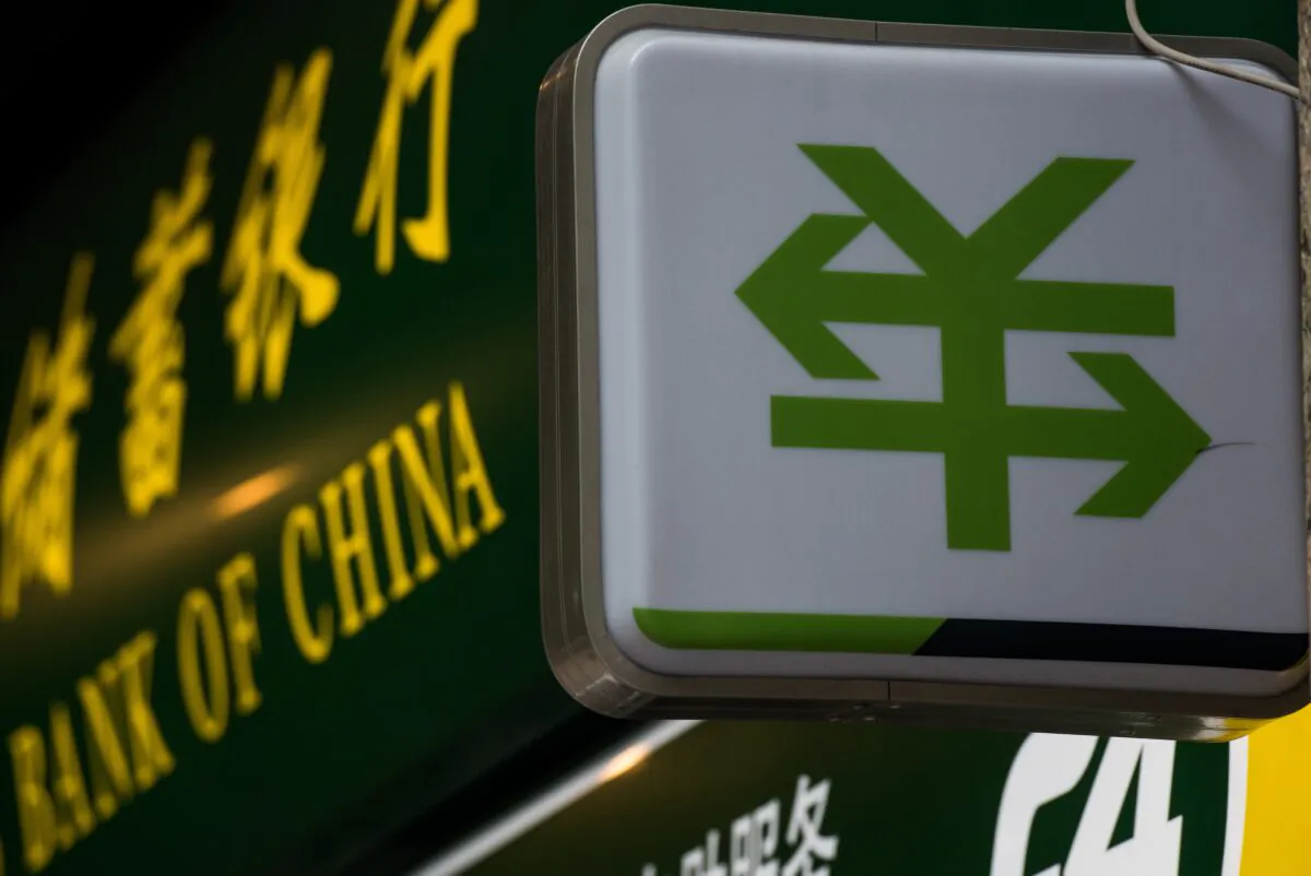 A Chinese yuan currency sign with two arrows is pictured outside a bank branch of the People’s Bank of China in Shanghai on Aug. 13, 2015. (Johannes Eisele/AFP via Getty Images)
