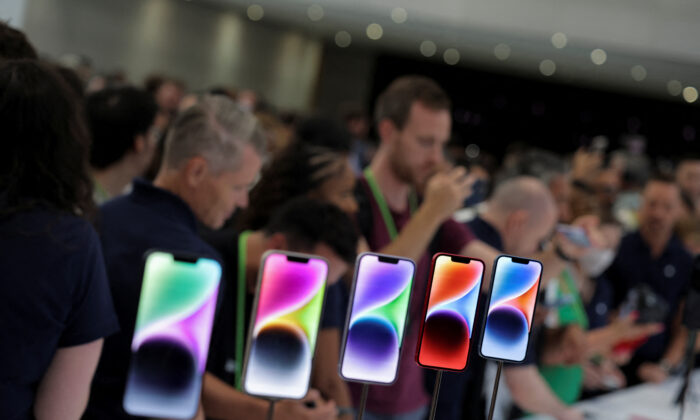 Guests look at the new iPhone 14 at an Apple event at their headquarters in Cupertino, Calif., on Sept. 7, 2022. (Carlos Barria/Reuters)