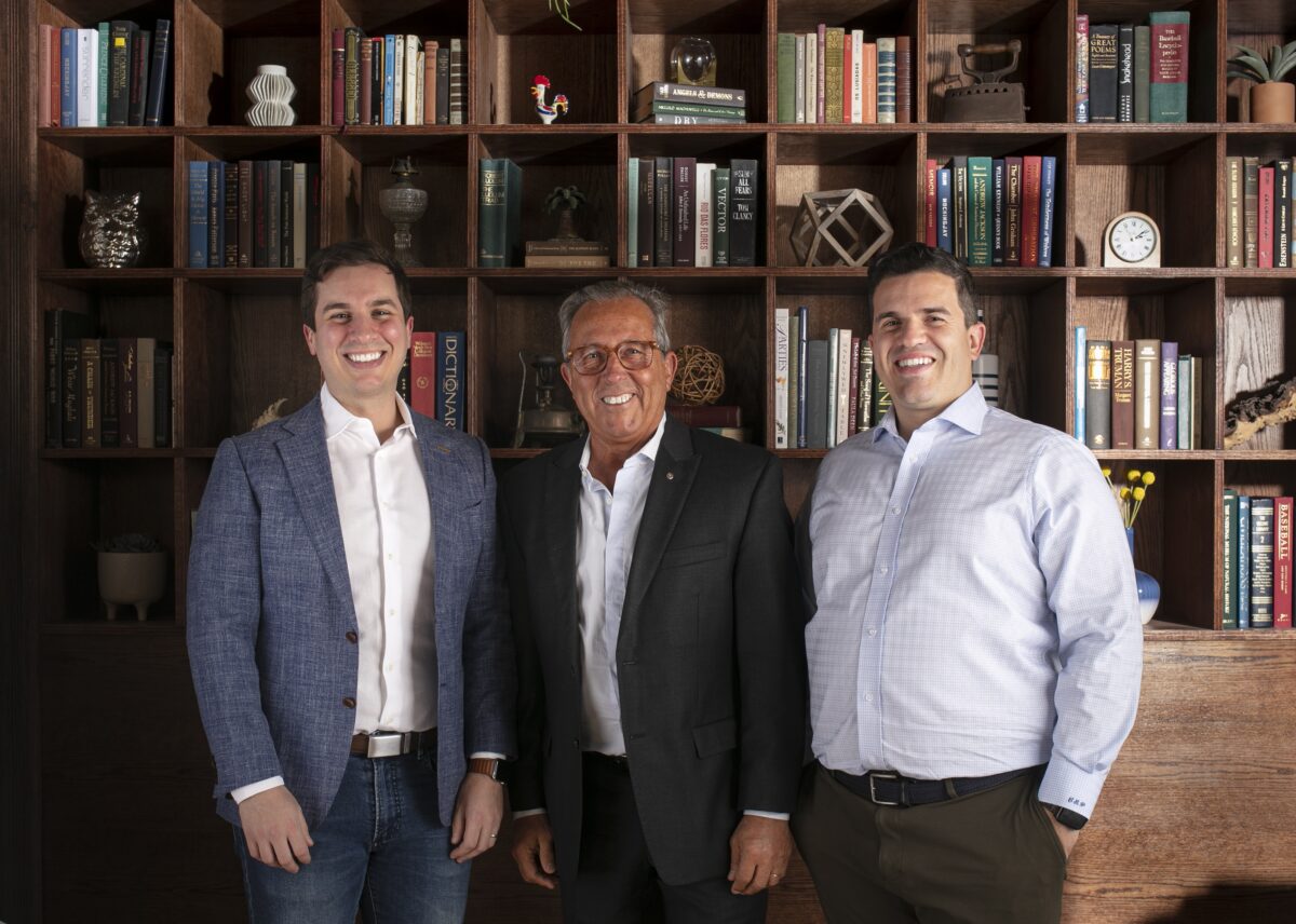 (From L to R) Victor, Alfredo, and Carlos Pedro in the private dining room at Ipanema. Behind them, family heirlooms and books line the shelves. (Melissa Hom)