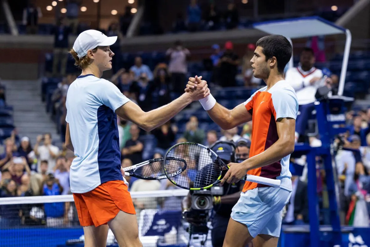 Spain's Carlos Alcaraz (R) greets Italy's Jannik Sinner at the net after winning their 2022 US Open Tennis tournament men's singles quarter-final match against at the USTA Billie Jean King National Tennis Center in New York, on early September 8, 2022. (Photo by Corey Sipkin/AFP via Getty Images)