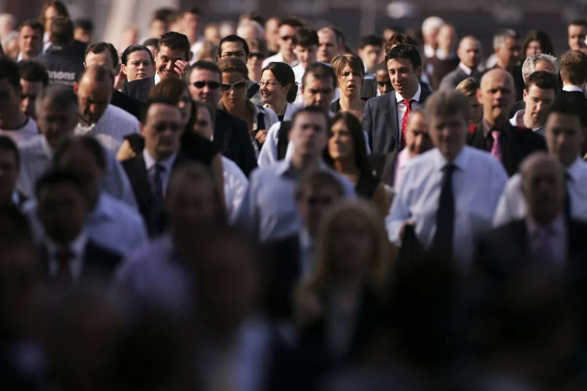 London City workers walk across London bridge on June 8, 2006 in London. (Bruno Vincent/Getty Images)