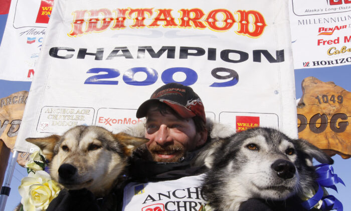 Lance Mackey sits with his lead dogs Larry (R) and Maple after crossing the finish line of the Iditarod Trail Sled Dog Race to win his third Iditarod in a row in Nome, Alaska, on March 18, 2009. (Al Grillo/AP Photo)