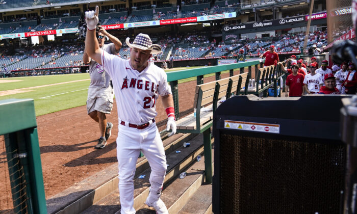 Los Angeles Angels center fielder Mike Trout (27) celebrates in the dugout after hitting a home run during the fifth inning of a baseball game against the Detroit Tigers in Anaheim, Calif., on Sept. 7, 2022. (Ashley Landis/AP Photo)