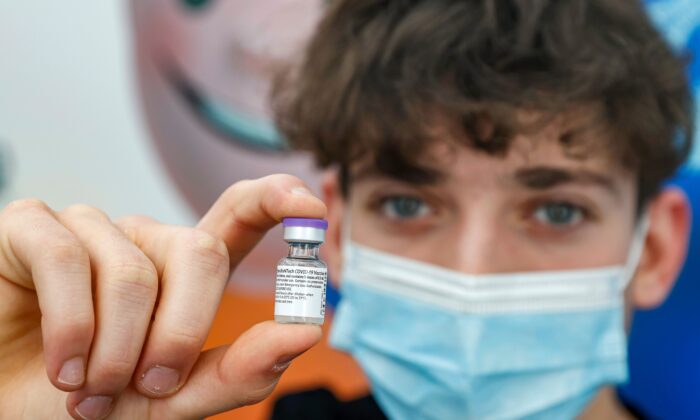 A 16-year-old teenager receives a dose of the Pfizer-BioNtech COVID-19 vaccine at Clalit Health Services, in Israel's Mediterranean coastal city of Tel Aviv on Jan. 23, 2021. (Jack Guez/AFP via Getty Images)