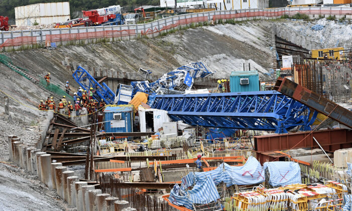 A crane collapsed at a construction site on Anderson Road, Hong Kong, fell onto several shipping containers that were temporary offices, and caused 3 deaths and 6 injuries, on Sept. 8. (Sung Pi-Lung / The Epoch Times)
