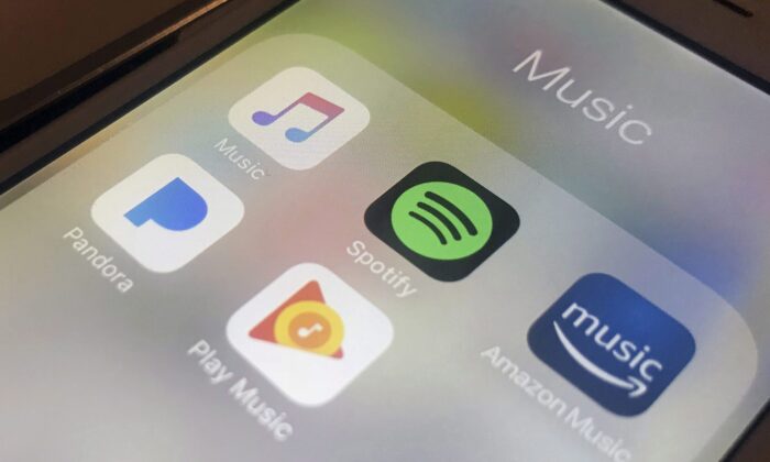 Music streaming apps clockwise from top left, Apple, Spotify, Amazon, Pandora, and Google on an iPhone are seen in a file photo taken in New York on Jan. 28, 2018. (AP Photo/Jenny Kane)