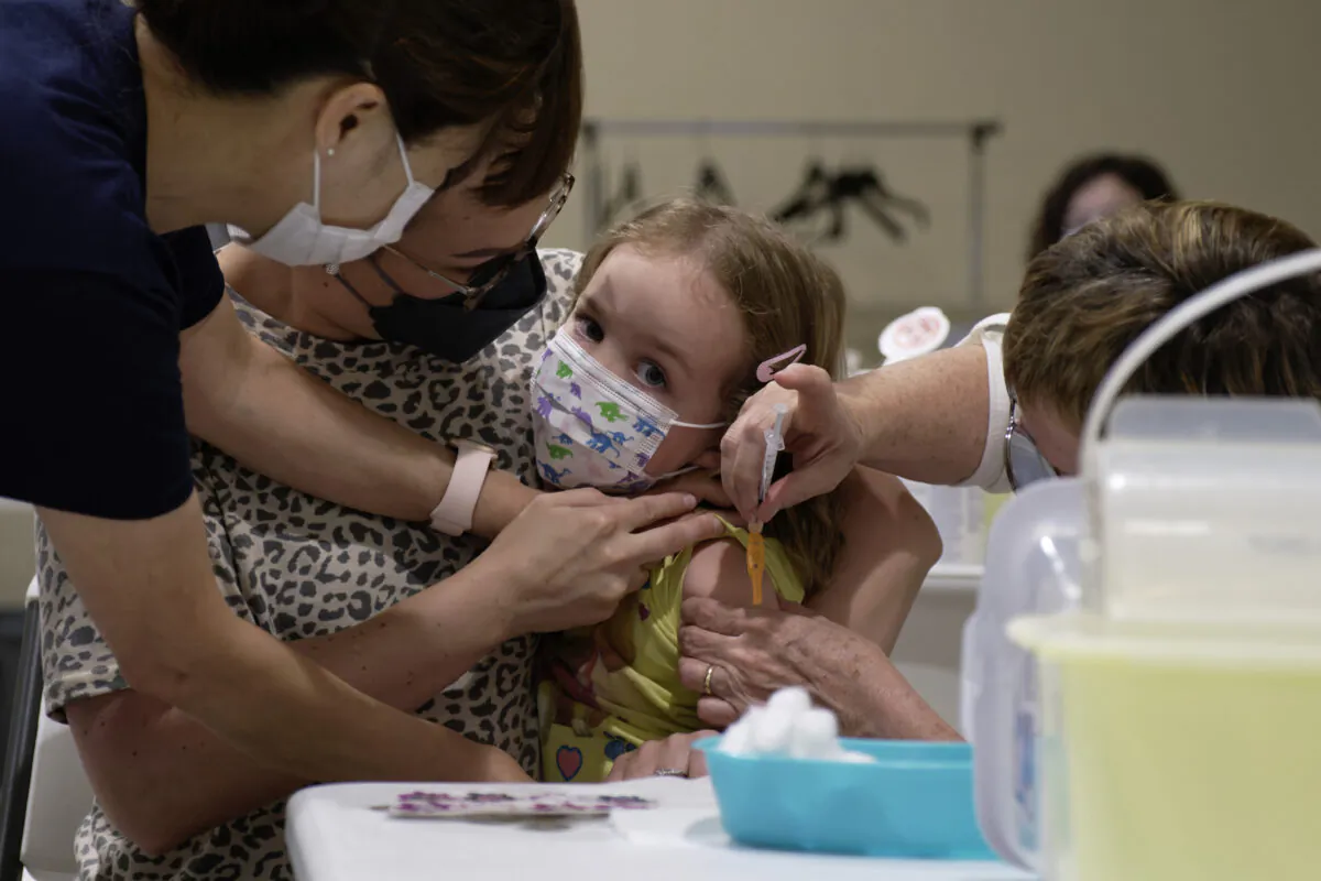 Khloe Robins, 3, gets a COVID-19 vaccination shot at a clinic in the Victoria Square Mall in Regina on July 22, 2022. (Michael Bell/The Canadian Press)