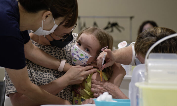 Khloe Robins, 3, gets a COVID-19 vaccination shot at a clinic in the Victoria Square Mall in Regina on July 22, 2022. (Michael Bell/The Canadian Press)