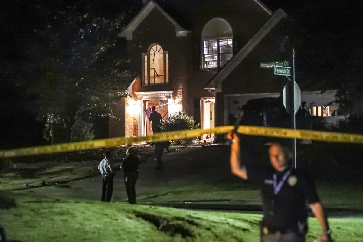 Law enforcement officials investigate the scene of a shooting in Cobb County, Ga., early on Sept. 9, 2022. (John Spink/Atlanta Journal-Constitution via AP)