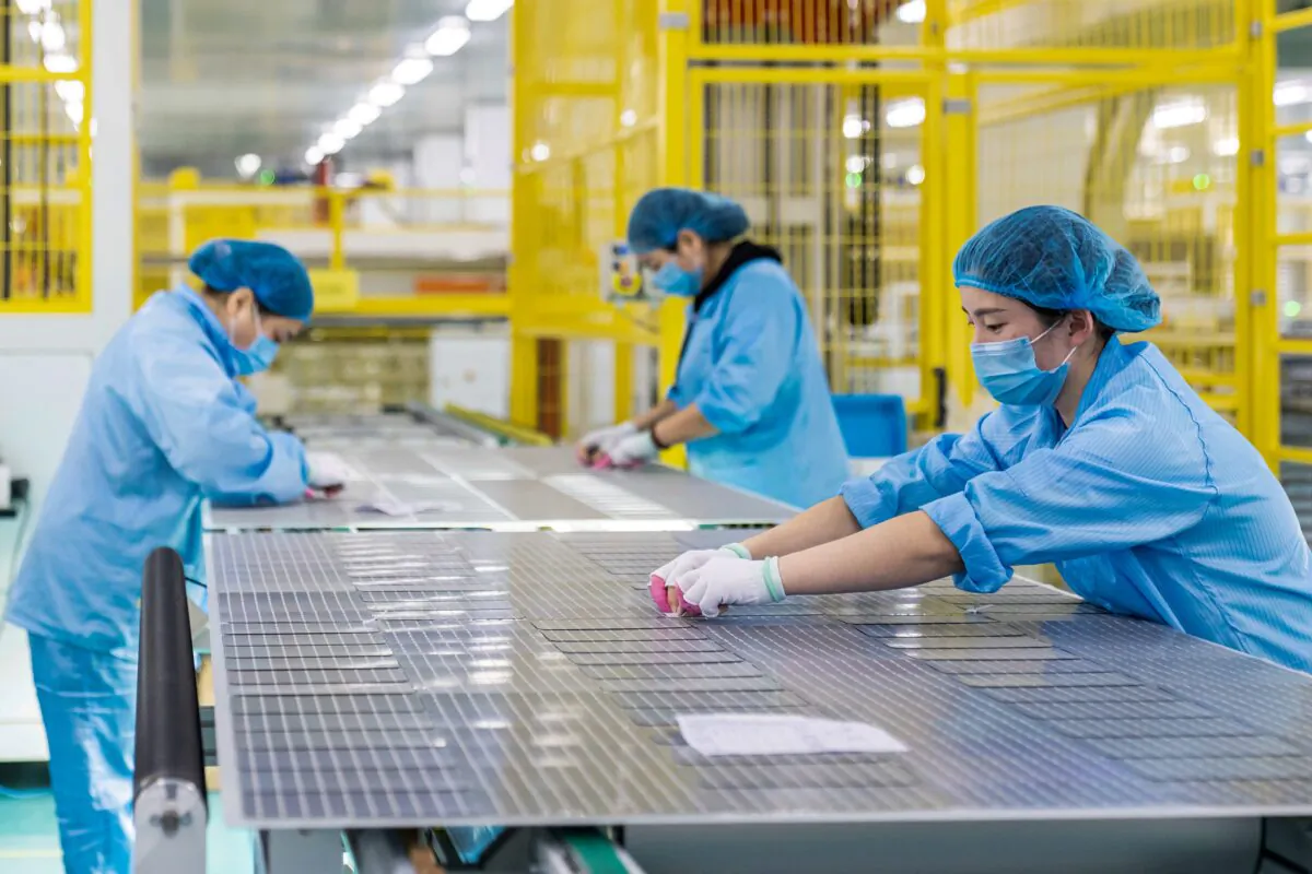 Workers are making solar photovoltaic modules used for small solar panels at a factory in Haian in China's eastern Jiangsu Province on Jan. 7, 2022. (STR/AFP via Getty Images)