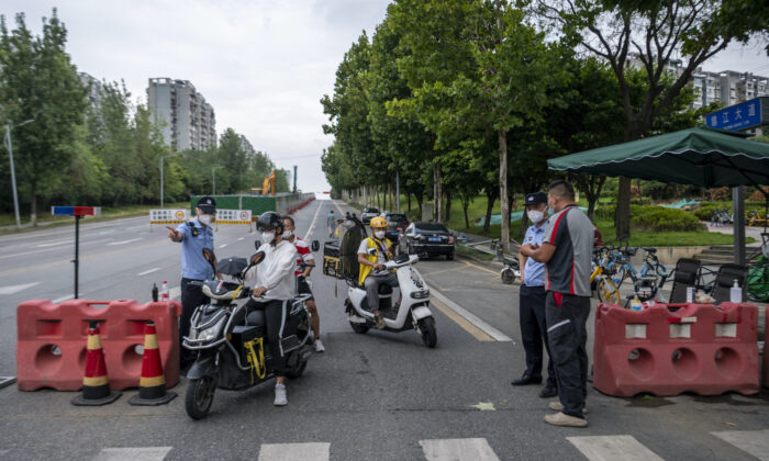 Police officers check people’s information at a roadblock on Sept.1, 2022, amid restrictions due to an outbreak of COVID-19 in Chengdu, southwestern Sichuan Province, China. (CNS/AFP via Getty Images)