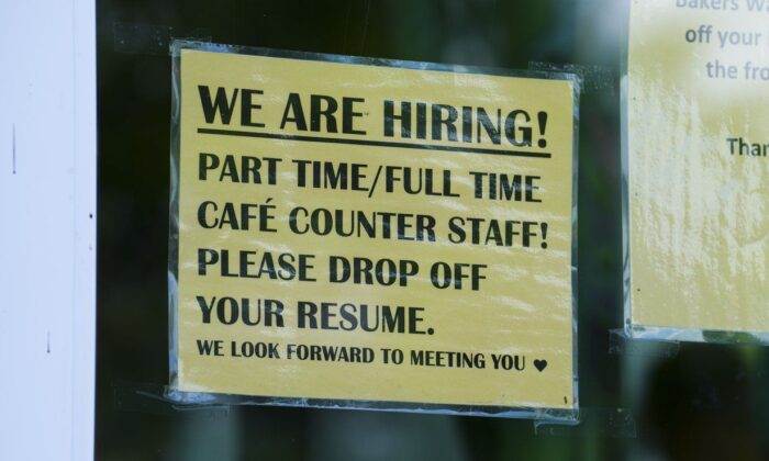 A sign for help wanted is pictured in a business window in Ottawa on July 12, 2022. (The Canadian Press/Sean Kilpatrick)