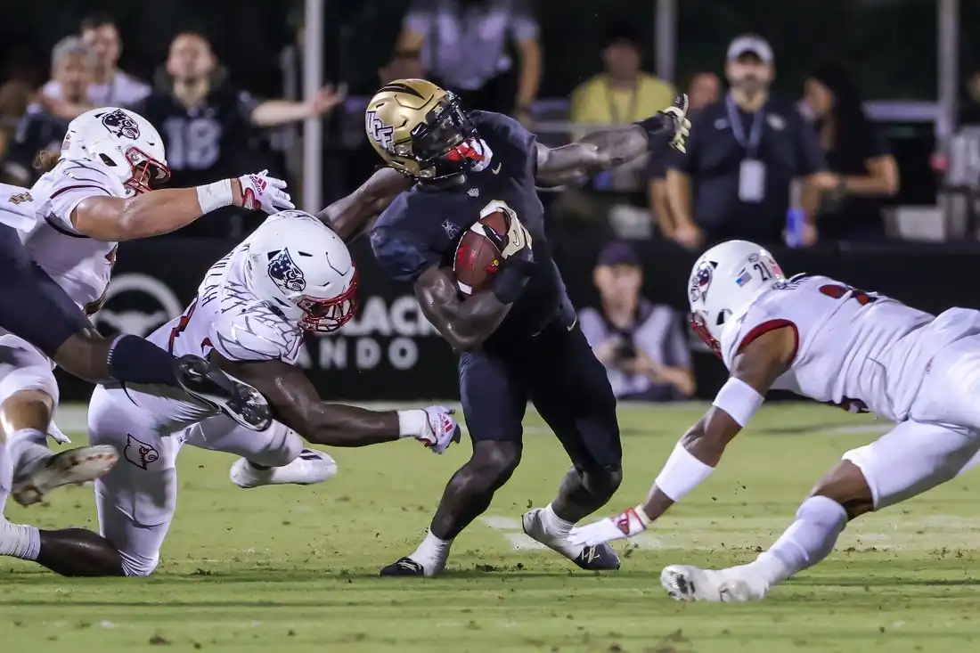 UCF Knights running back Jordan McDonald (9) is tackled by Louisville Cardinals linebacker Yasir Abdullah (22) during the second quarter at FBC Mortgage Stadium in Orlando, Flor., on Sept. 9, 2022. (Mike Watters/USA TODAY Sports via Field Level Media)